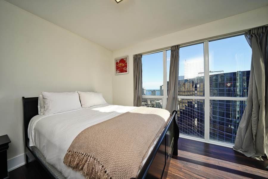 Open kitchen and dining area in a RivetStays-managed condo suite at The Atmos, Toronto